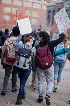Rachel Mitchell (left) and Lashelle Ramirez (Right), both juniors, march together in Wednesday's 'Sanctuary Campus' protest.