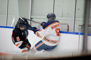 Allie Munroe, pictured earlier this season against Princeton, crashing into the boards. 