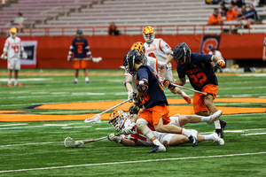 Danny Varello, pictured against Virginia, reaching for a groundball. 