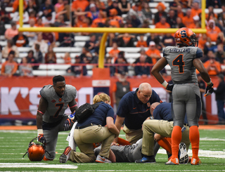 Etta-Tawo kneels by Dungey's side as the quarterback was looked at by trainers. Dungey eventually returned to the game. 