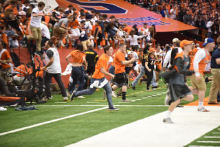Syracuse students rush the field after the Orange's shocking win over Virginia Tech. SU last beat a ranked team when the Orange played Louisville in 2012 in what was Doug Marrone's last season as head coach. 