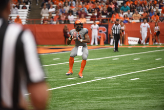 Orange running back Dontae Strickland fires a trick-play pass down the field. SU ran multiple throwback passes and fakes against VT.
