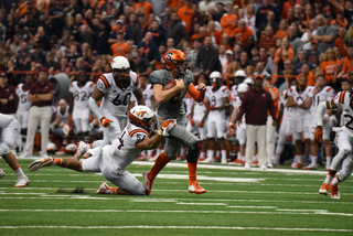 Dungey tries to slip away from Virginia Tech linebacker Andrew Motuapuaka. The latter had four solo tackles and eight total tackles. 