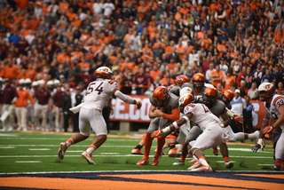 Dungey lowers his body toward the goal line during SU's win over VT. He ran for more than 100 yards and scored a touchdown on the ground. 